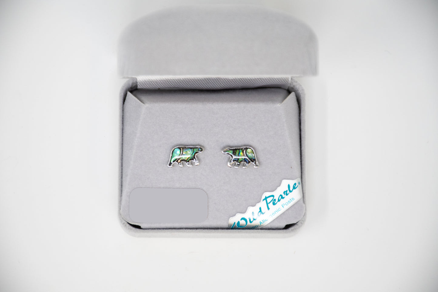 Pair of bear-shaped earrings in a jewelry box on a white background