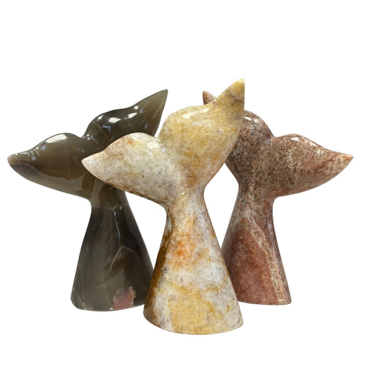 Three marble sculptures of whale tails