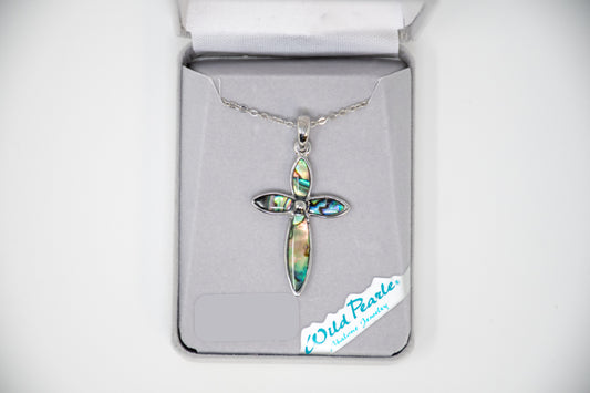 Cross-shaped pendant in a box labeled 'Wild Pearle'.