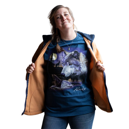 Person wearing a blue t-shirt with wolf design and an orange jacket