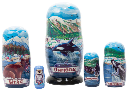 Set of nesting dolls with scenic and Alaska animal-themed designs on a white background