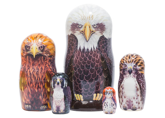 Set of nesting dolls with eagle design on a white background