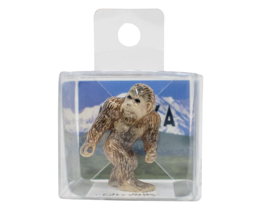 Sasquatch figurine in packaging with mountain background