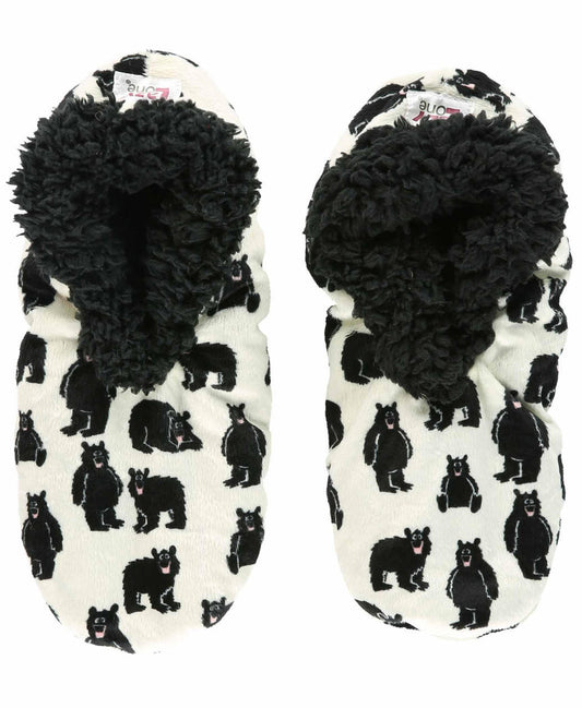 Pair of black and white slippers with bear pattern on a white background