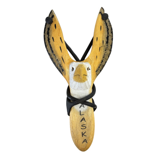 Wooden slingshot with a carved eagle face and 'Alaska' inscription