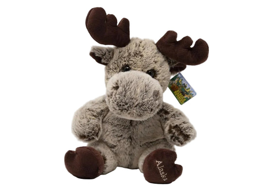 Plush moose toy with a tag on a white background