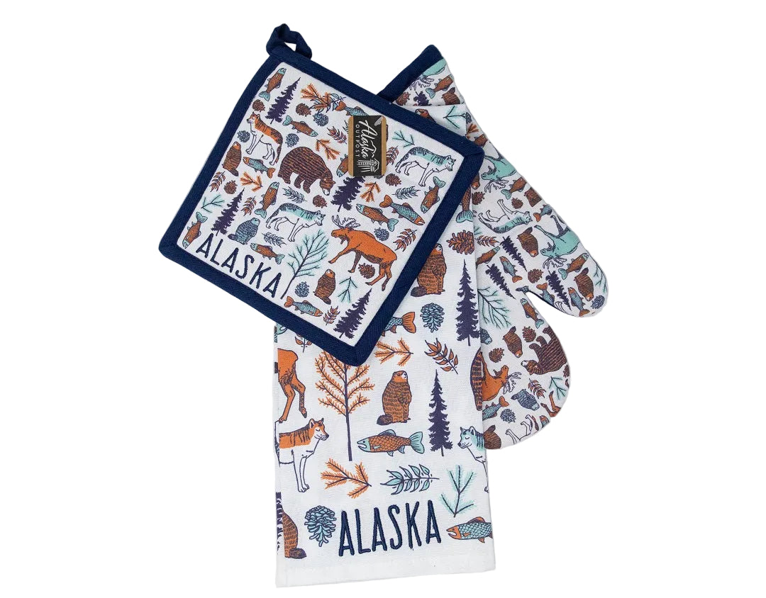Set of kitchen gloves and pot holders with nature-themed design and 'Alaska' text