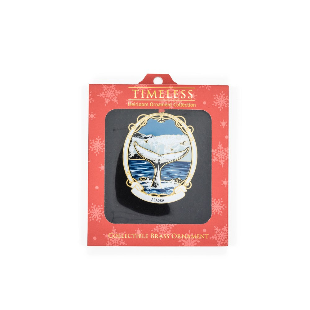 Collectible brass ornament in packaging with 'Timeless' branding