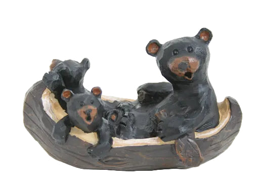 Decorative figurine of bears in a canoe on a white background