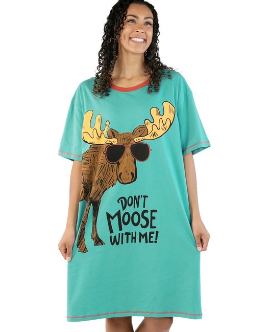 Woman wearing a teal nightshirt with a moose graphic and text on a white background
