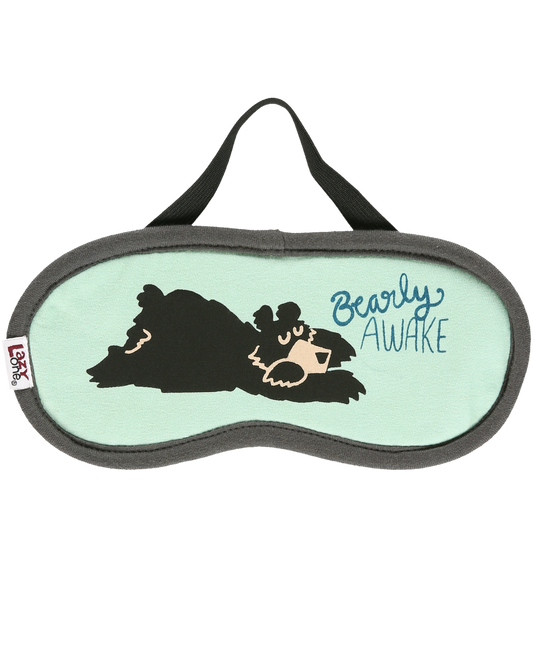 Sleep mask with bear design and 'Bearly Awake' text on a light green background