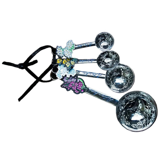 Set of four measuring spoons with decorative handles