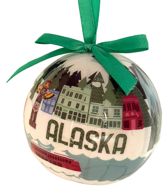 Decorative ornament with 'Alaska' text and green ribbon on a light background
