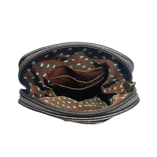 Close-up of an open crossbody bag with a zipper, showing the interior with a polka dot pattern.