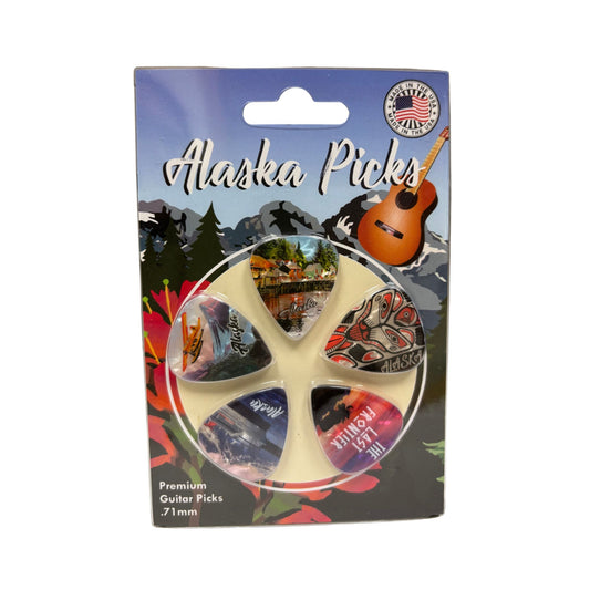 Packaging of Alaska Picks with guitar picks inside, featuring scenic designs.