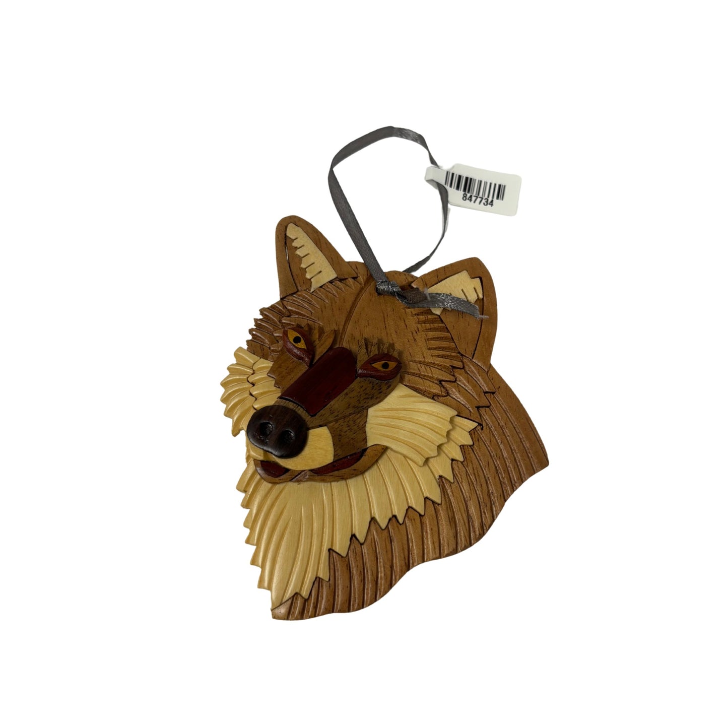 Wooden wolf head ornament with a tag on a white background