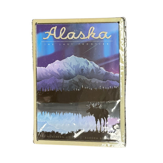 Packaged tin poster with 'Alaska' and mountain landscape design on a white background