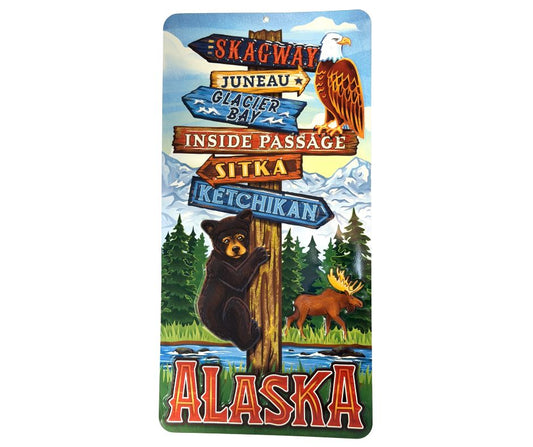 Decorative sign with Alaska-themed elements including a bear, moose, and scenic landscapes.