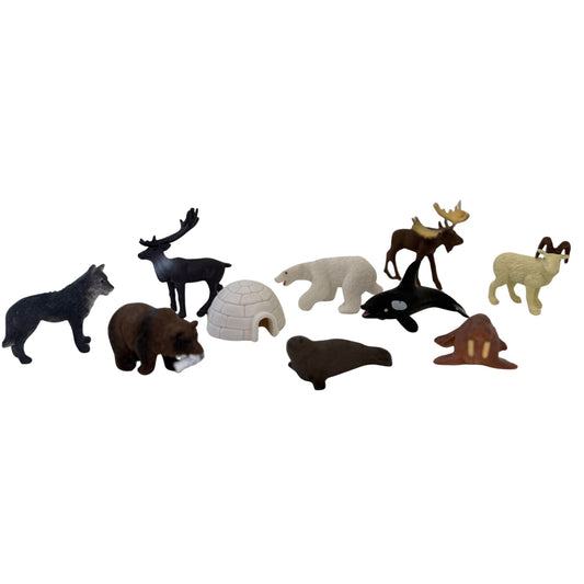 Collection of toy animal figures on a white background