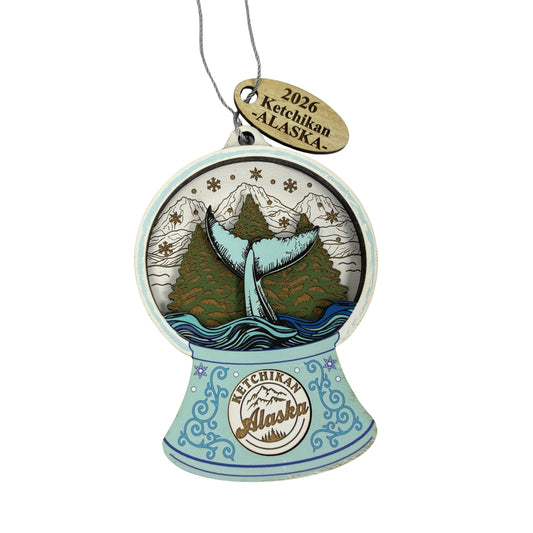 Decorative ornament with whale and mountain design, featuring '2026 Ketchikan Alaska' text.
