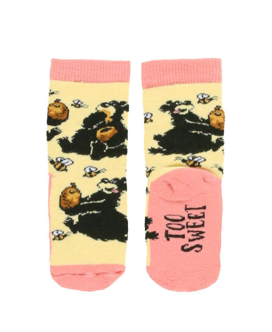Pair of socks with a black bear and honey design on a yellow background, with pink accents.