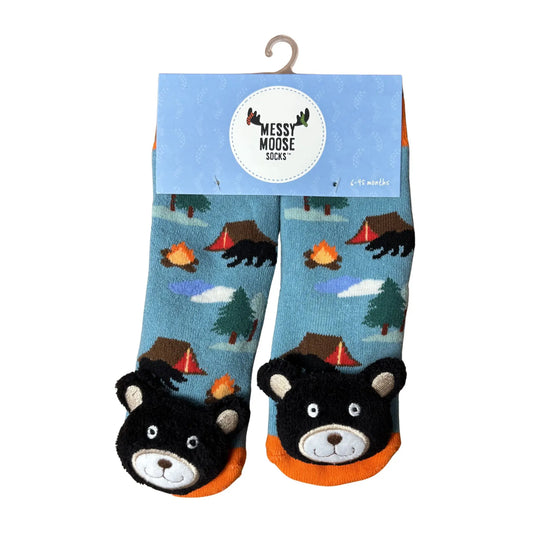 Pair of children's socks with bear and camping design on a blue background.
