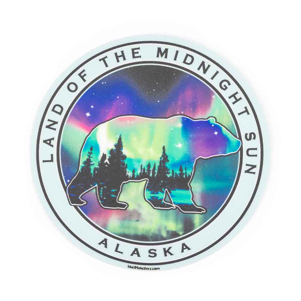 Sticker with bear silhouette, forest, the northern lights and 'Land of the Midnight Sun, Alaska'