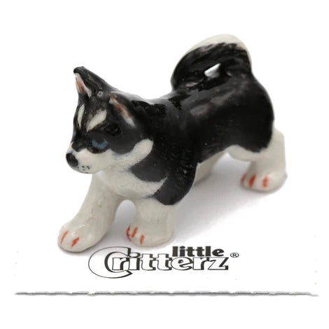 Small black and white husky figurine