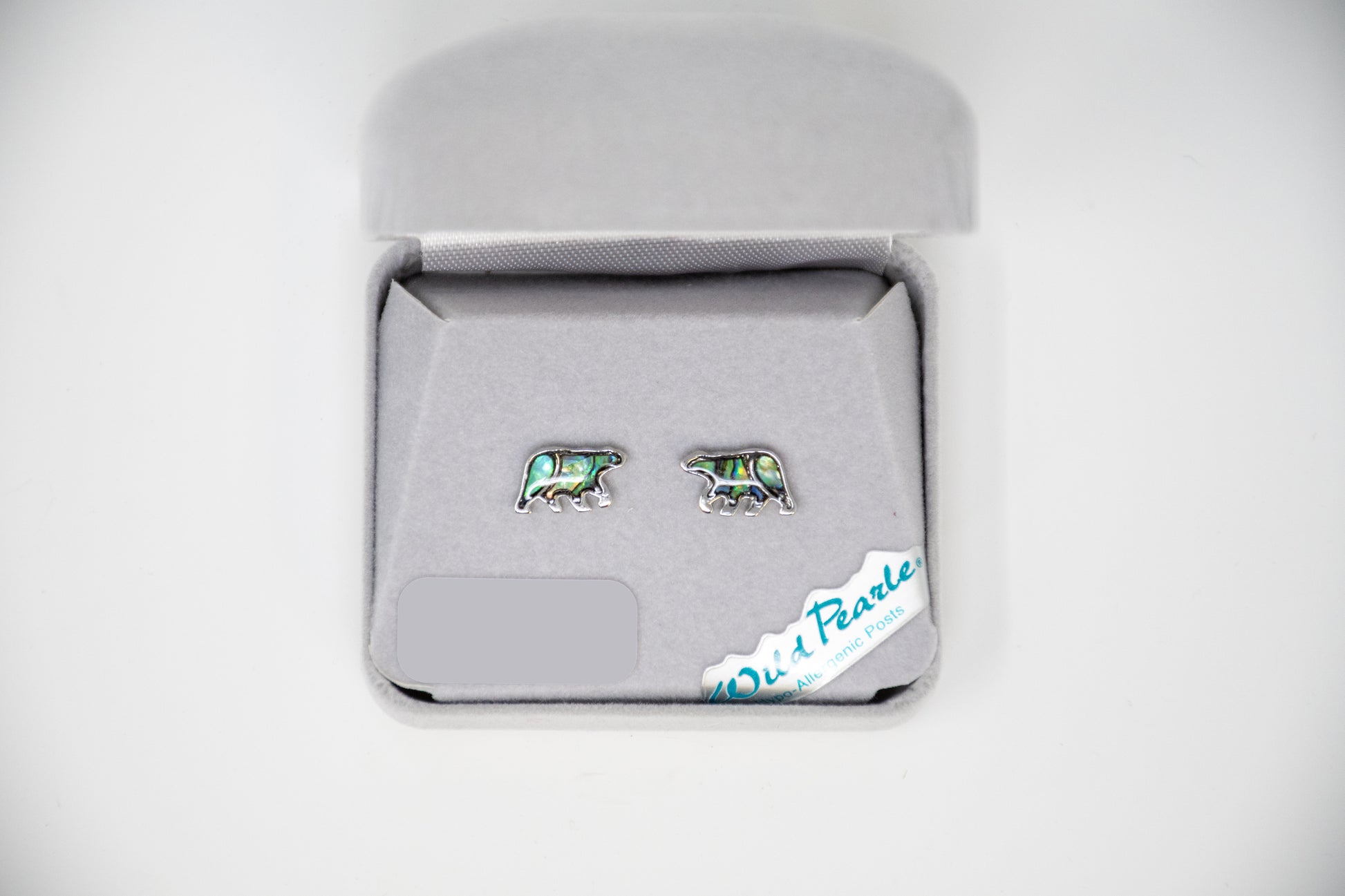 Pair of bear-shaped earrings in a jewelry box on a white background