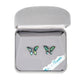 A pair of butterfly earrings in a box