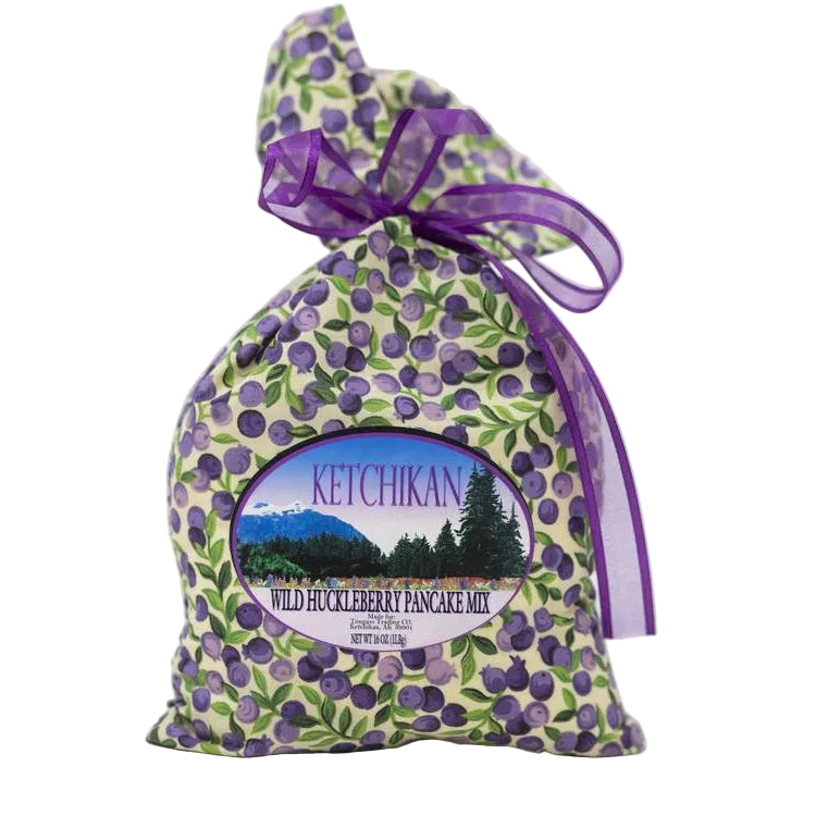 Ketchikan Wild Huckleberry Pancake Mix packaging with a purple ribbon on a white background
