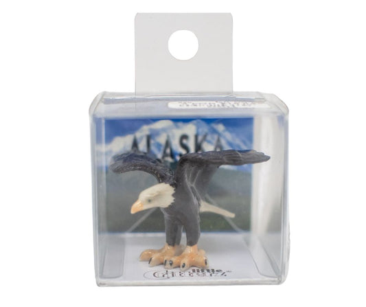 Eagle figurine in clear packaging with Alaska background