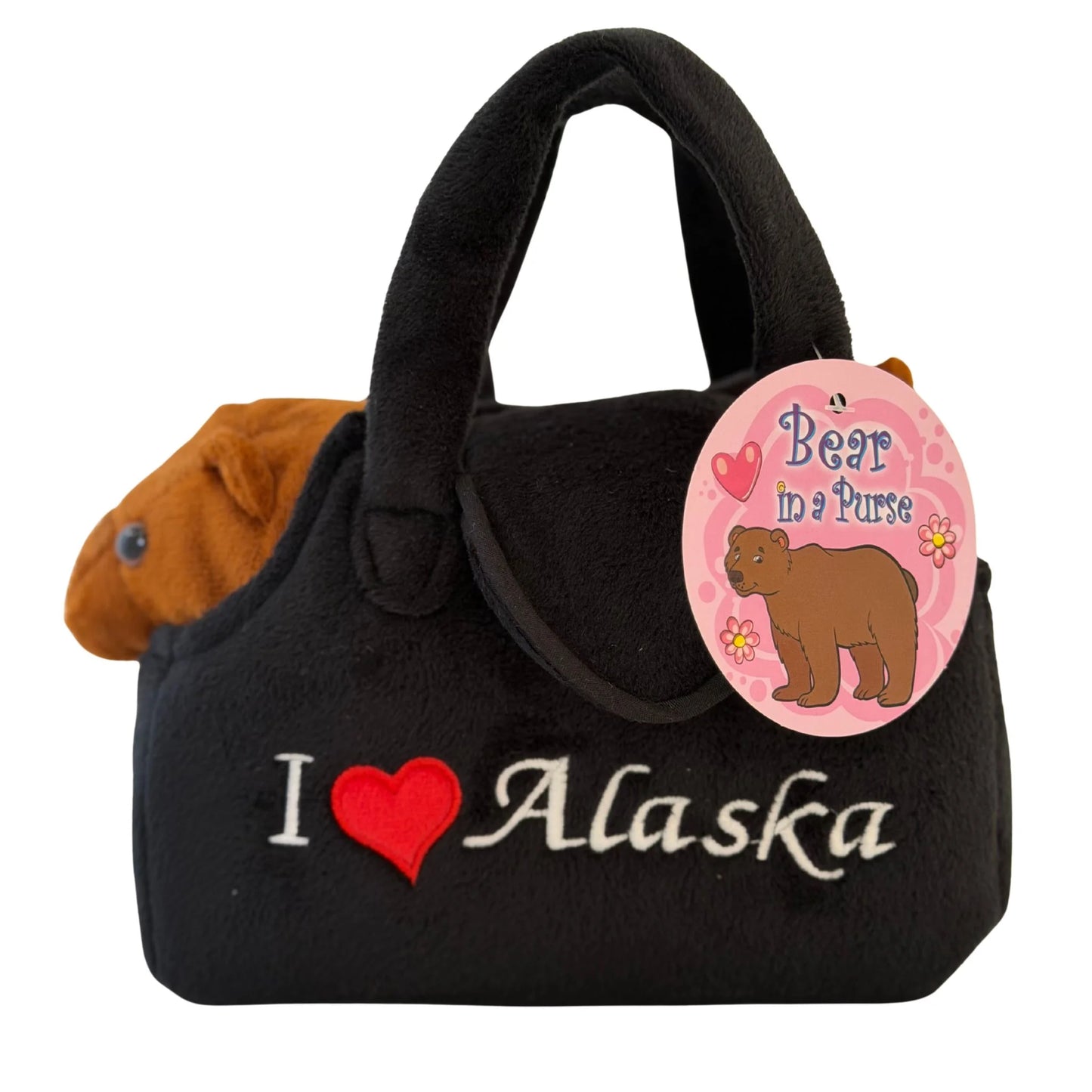 Black purse with a bear toy inside and 'I ❤️ Alaska' text.