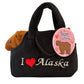 Black purse with a bear toy inside and 'I ❤️ Alaska' text.