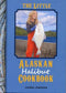Book cover of 'The Little Alaskan Halibut Cookbook' with a photo of a person holding a halibut on a dock.