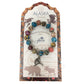 Colorful beaded bracelet with a metal Alaska charm on a branded card.