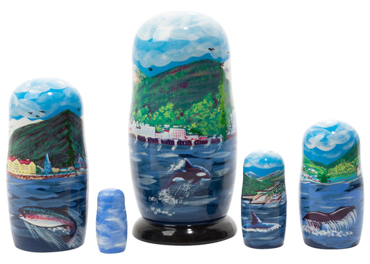 Set of nesting dolls with scenic designs featuring mountains, oceans, and wildlife.