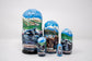 Set of Russian nesting dolls with Alaska-themed images on a white background