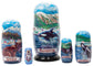 Set of nesting dolls with scenic and Alaska animal-themed designs on a white background