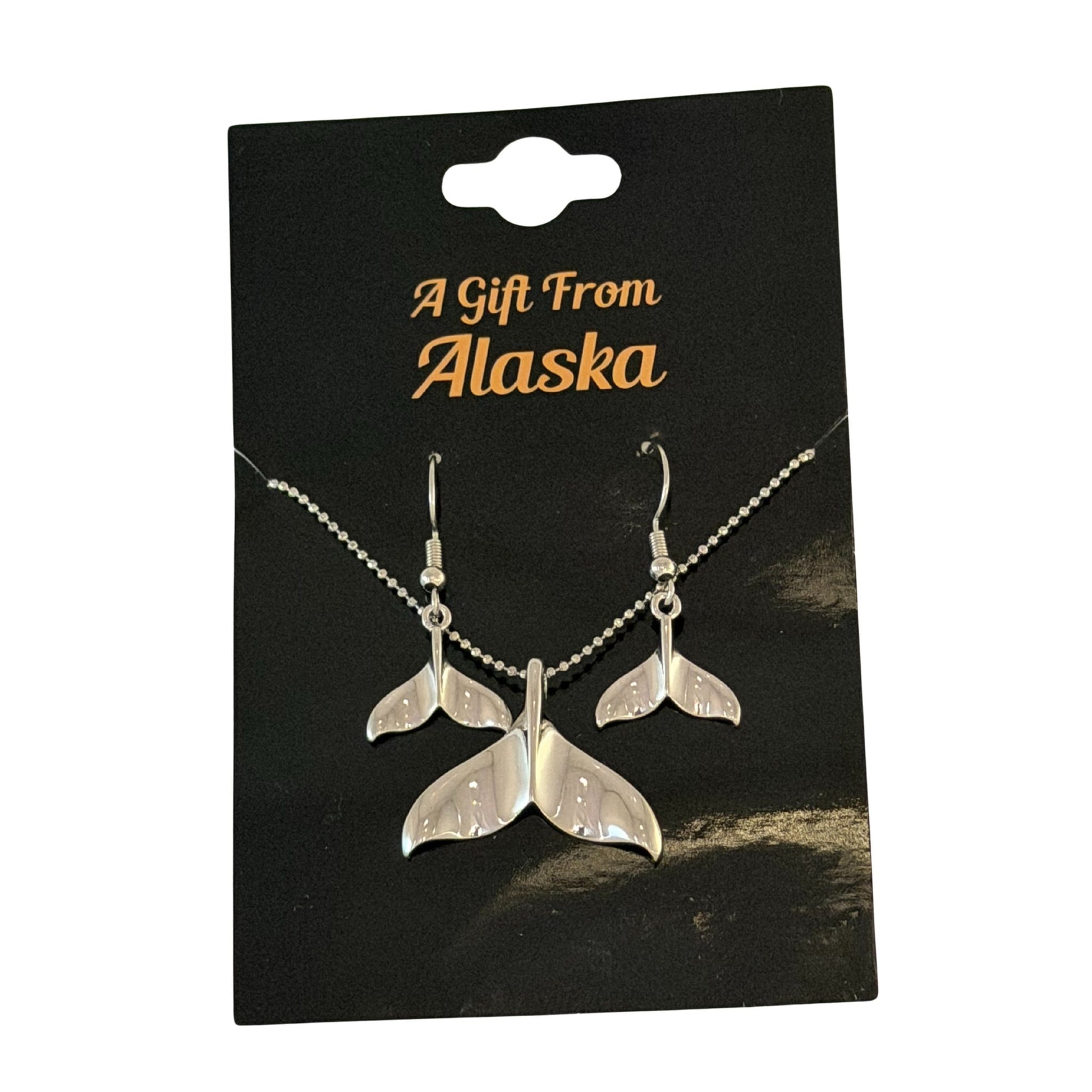 Silver whale tail necklace and earrings on a 'A Gift From Alaska' card.