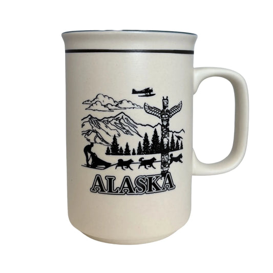 Cream mug with black Alaska-themed design on a white background