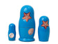 Set of three blue nesting dolls with starfish and shell designs on a white background