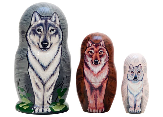 Three nesting dolls with wolf designs on a white background