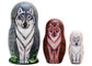 Three nesting dolls with wolf designs on a white background