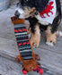 Dog playing with a moose-themed toy on a wooden deck