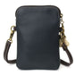 Back of crossbody bag with gold accents on a white background