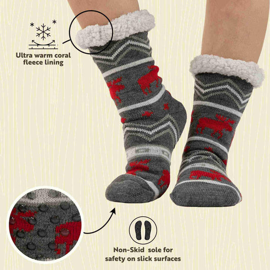 Gray socks with red patterns worn by a person on a beige background, highlighting fleece lining and non-skid sole.