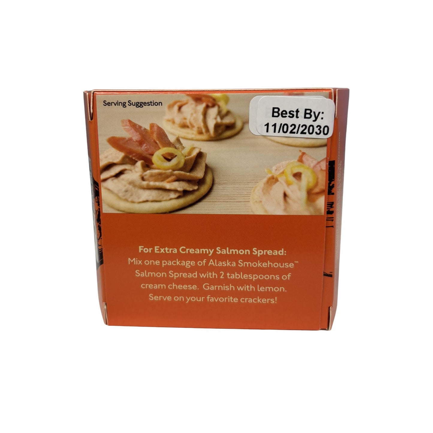 Box of Alaska Smokehouse Salmon Spread with serving suggestion and best by date label.
