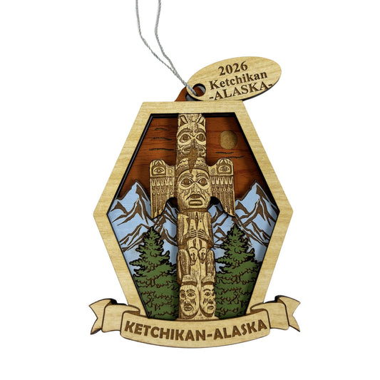 Wooden ornament featuring a totem pole and Ketchikan Alaska Text