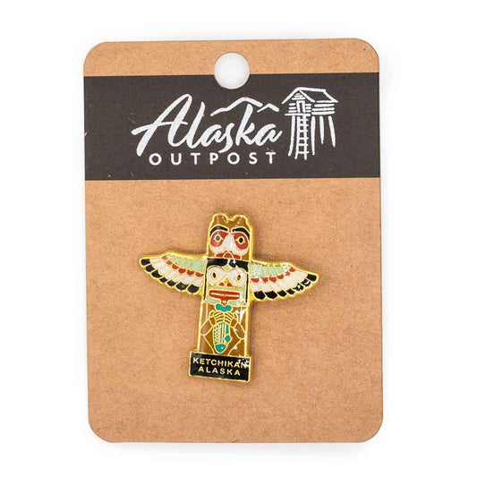 Colorful totem pin on a card with 'Alaska Outpost' branding